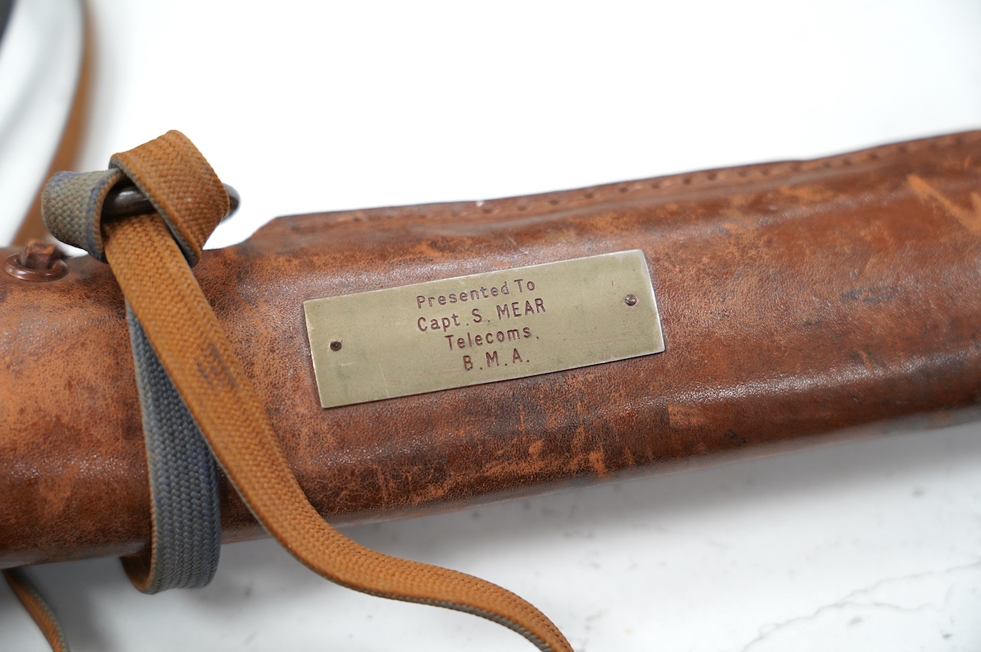 A Japanese WWII army officer’s sword Katana, blade 57.9cm, signed and dated with Seki Arsenal stamp, retaining good polish, in shin gunto mounts with leather combat cover on hilt and scabbard, the latter with plate stamp